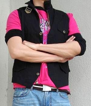 Pink t-shirt, black vest, light blue jeans