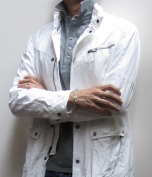 White jacket over a gray pique polo shirt
