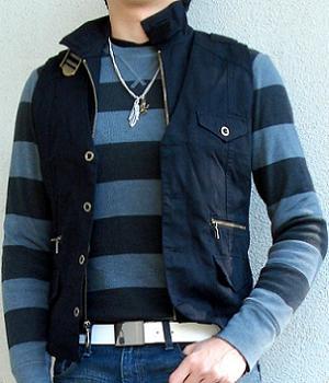 A black striped sweater under a black vest