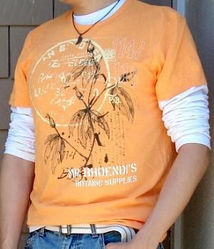 Orange Graphic Tee with a Small Bronze Pendant