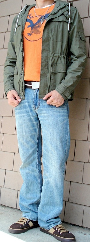 Men's Dark Green Jacket Orange Graphic Tee Brown Belt Light Blue Jeans